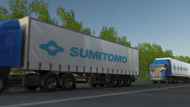 Freight semi trucks with Sumitomo Corporation logo driving along forest road. Editorial 3D rendering