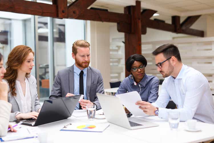 Business people discuss strategy with a financial analyst