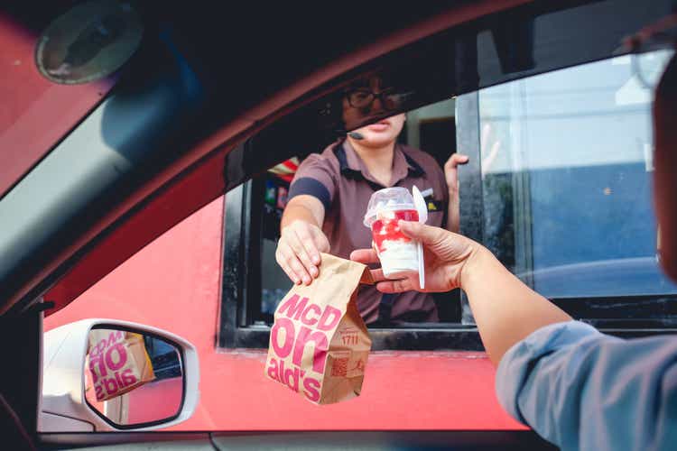 Bangkok, Thailand - Mar 4, 2017: customer receiving hamburger and ice cream after order and buy it from McDonald"s drive thru service