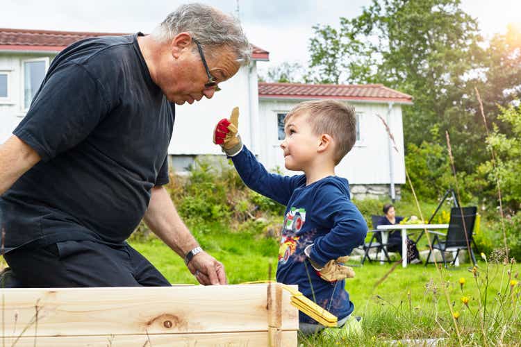 Boy helping Grandfather with joinery
