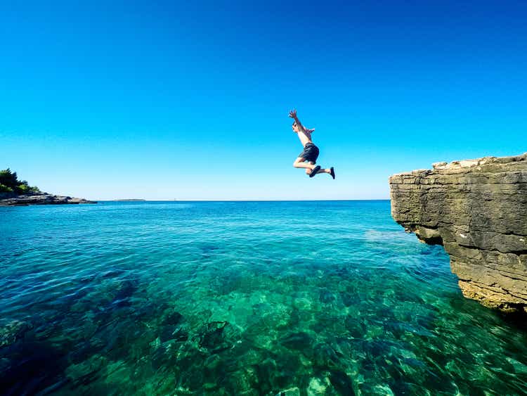 happy boy jumping in the croatian sea
