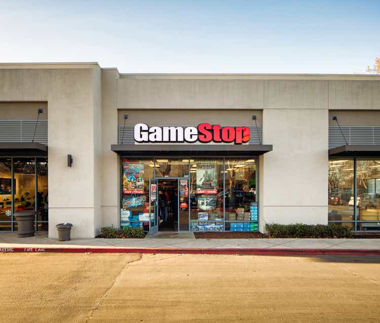 Gamestop video games store entrance facade in strip mall with sign