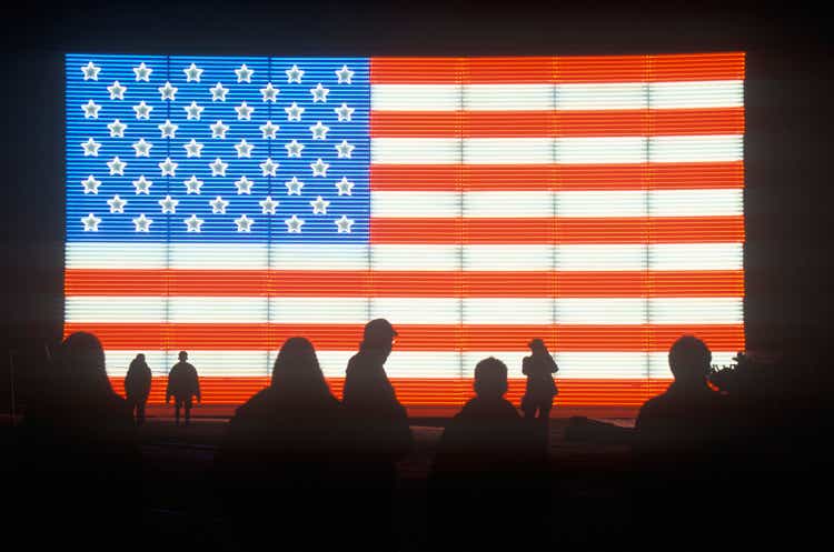 "Silhouettes of People in front of an American electric Flag, Winter Olympics, Salt Lake City, Utah"