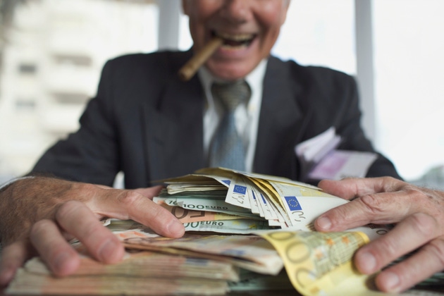 Man with cigar eagerly grasping a stack of Euros