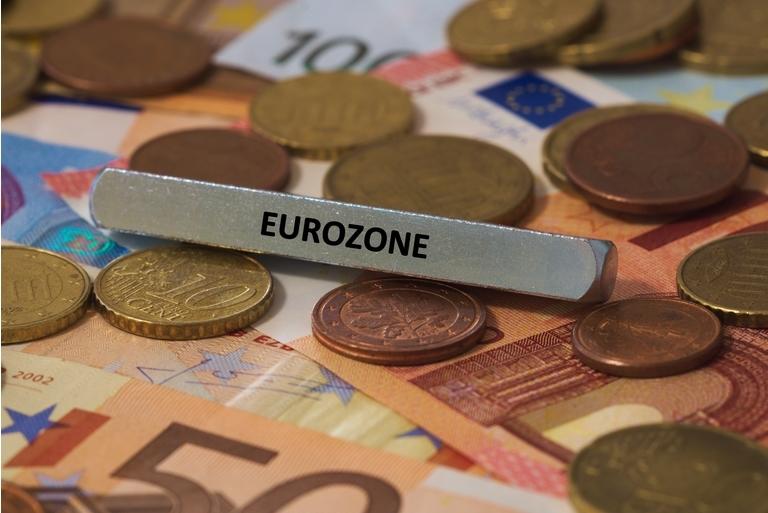 eurozone - the word was printed on a metal bar. the metal bar was placed on several banknotes