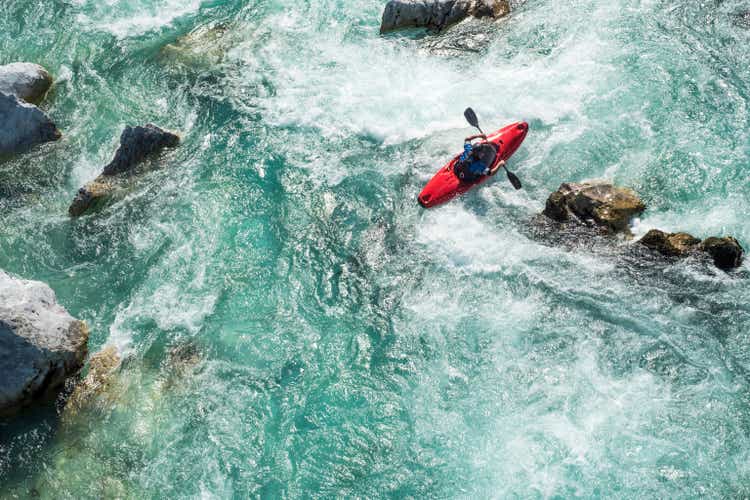 Mature Man Kayaking On River Soca Rapids - High Angle View