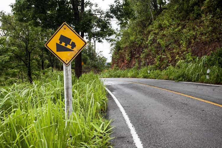 The street sign down hill warning on the mountain road
