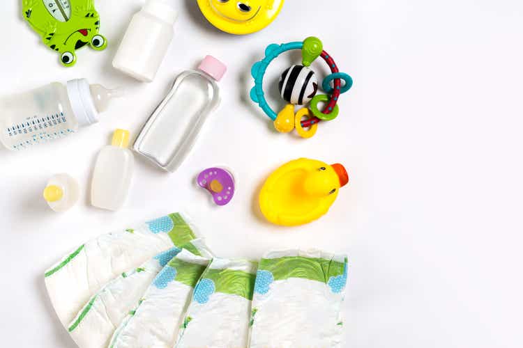 Babies goods diaper, baby powder, cream, shampoo, oil on white background with copy space. Top view or flat lay