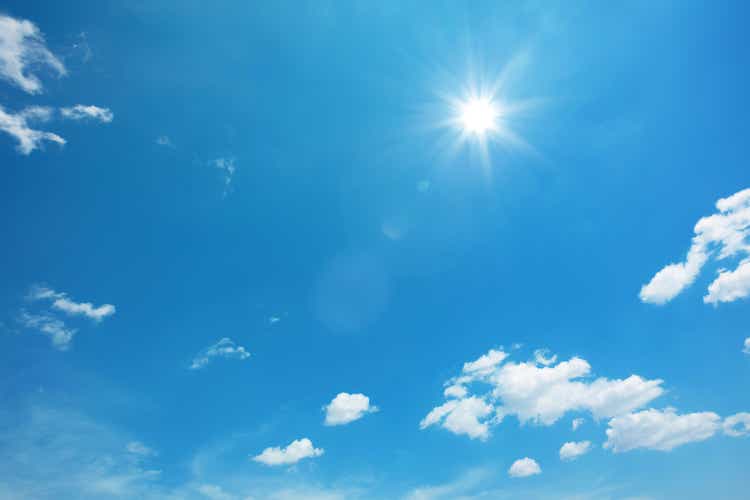 Sun in blue sky with clouds