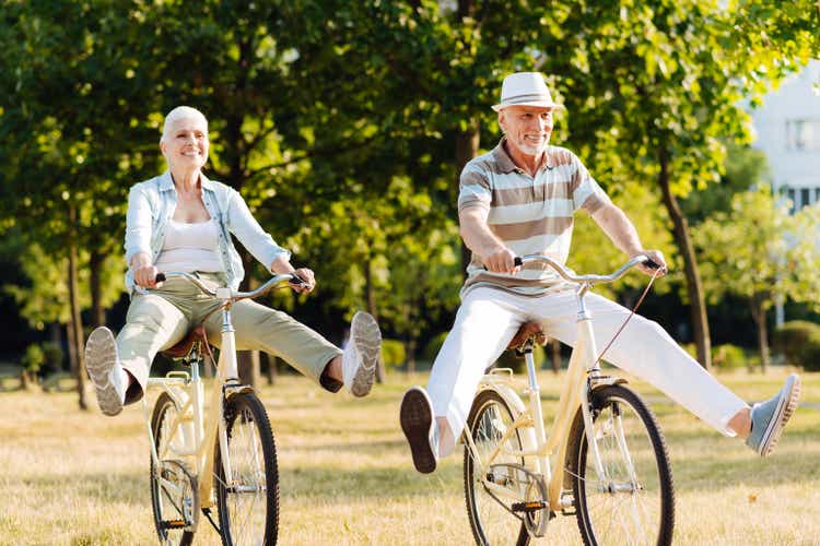 Joyful woman feeling happiness while cycling