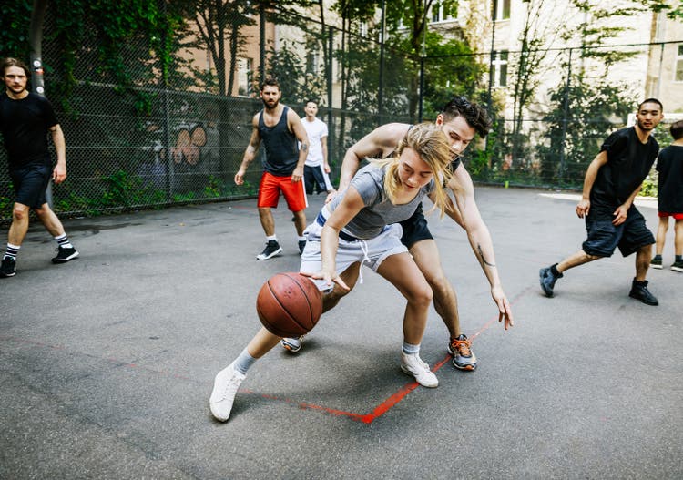 Amateur Athlete Defending Her Position During Basketball Game