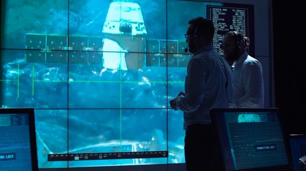 People controlling ship undocking