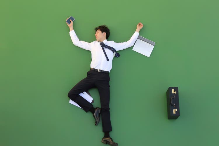 Young businessman sleeping on the floor