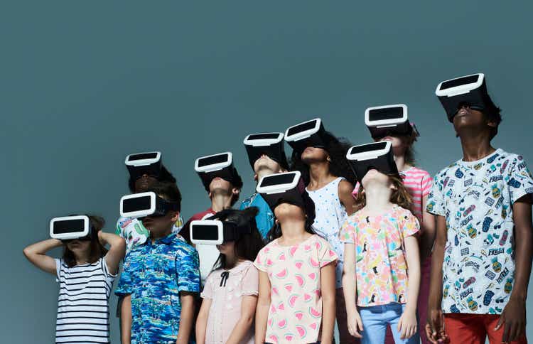 Group of children wearing virtual reality headsets