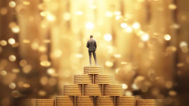 Businessman Standing with Umbrella Under the Money Rain