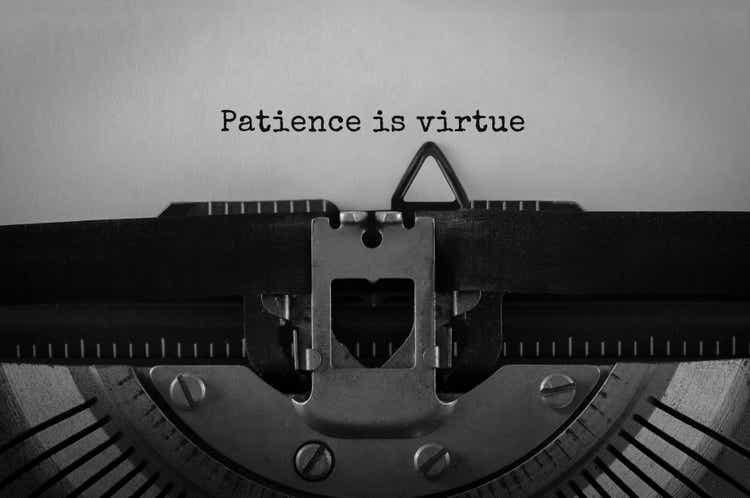 Text Patience is virtue typed on retro typewriter