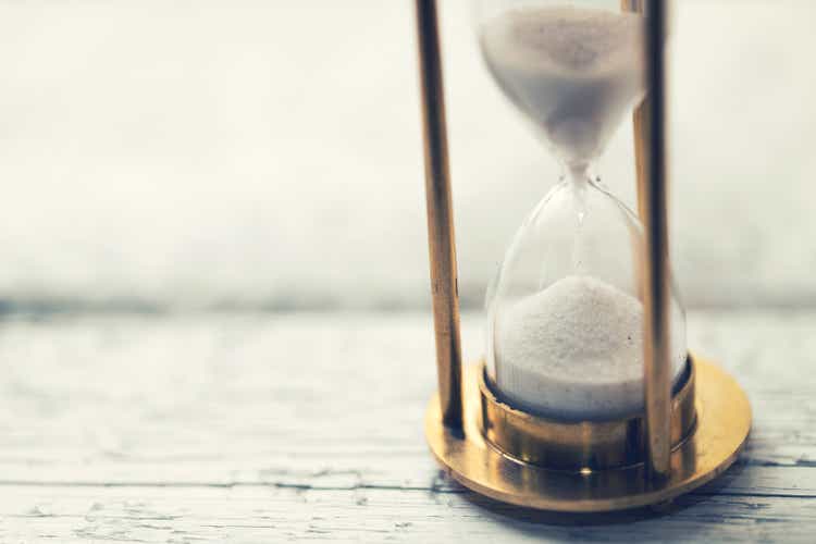 time is ticking - hourglass on the table with copy space