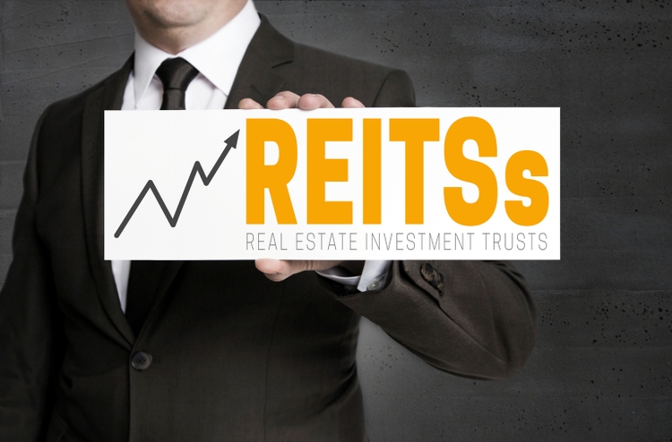 REITs sign is held by businessman