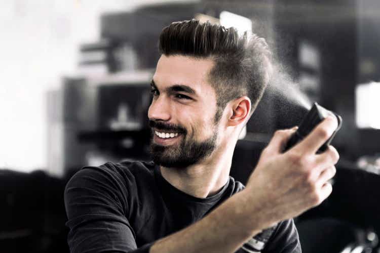Fashion guy using hairspray
