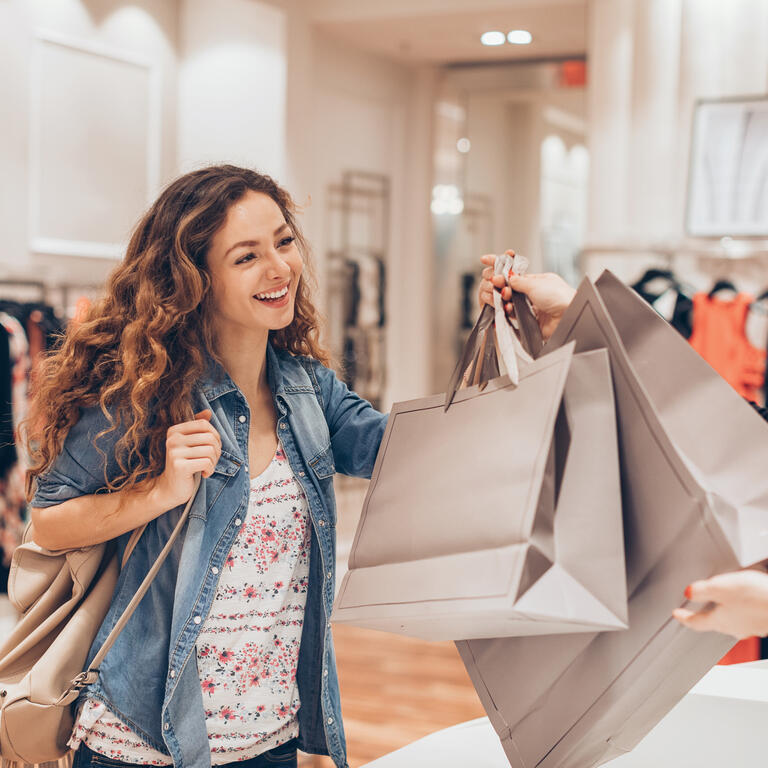 Happy girl shopping in the fashion store