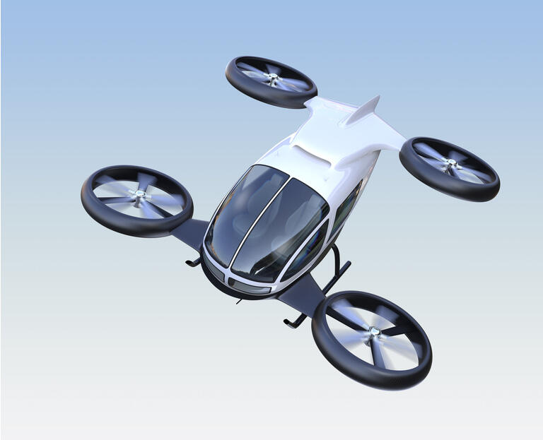 Front view of self-driving passenger drone flying in the sky