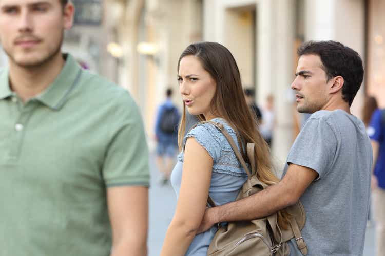 Disloyal woman looking another man and her angry boyfriend