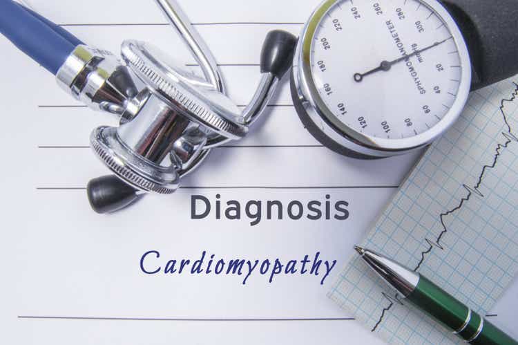 Cardiac diagnosis Cardiomyopathy. Medical form report with written diagnosis of Cardiomyopathy lying on table in doctor cabinet, surrounded by stethoscope, tonometer and ecg. Concept for cardiology