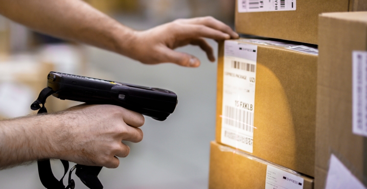 Manual worker scanning cardboard box