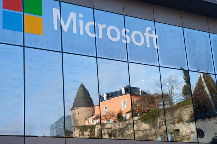 A reflection of mediaeval castle in windows of Microsoft"s office