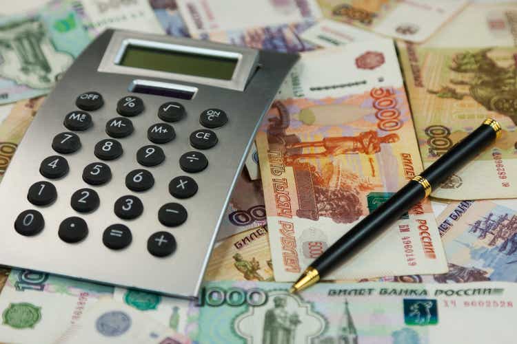 Calculator and money lie on the background of rubles. Ideas and concepts of business.