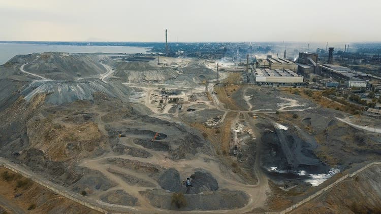Aerial view. Slag storage on the coast. A place for the storage of the slag. Large slag mountains. Slag pit