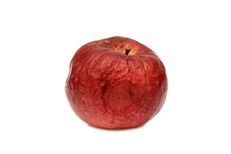 Red rotten apple on a white background, natural texture