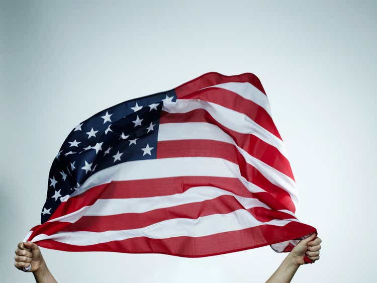 Hands holding American flag