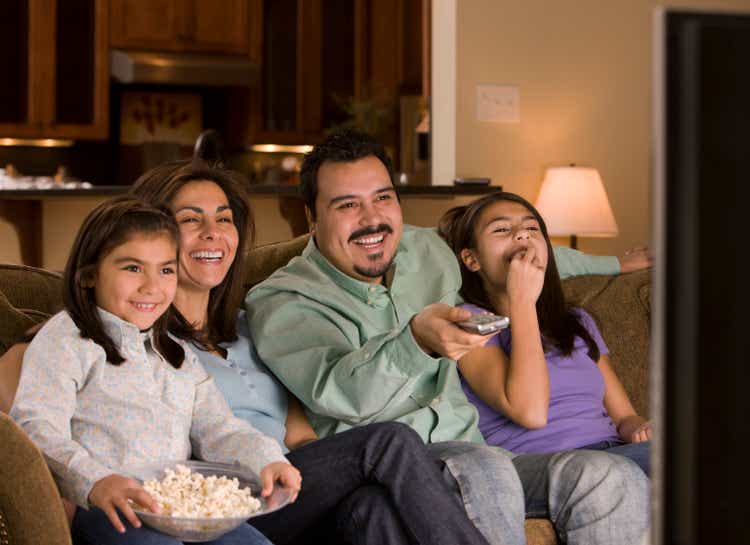 Hispanic family watching television together