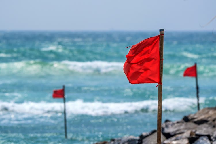 Red warning flag on beach