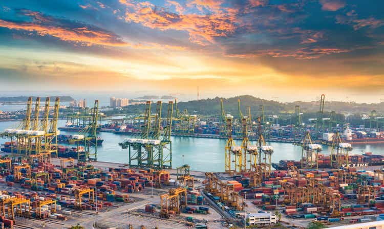 Container cargo ship with working overhead crane at a shipyard in Singapore