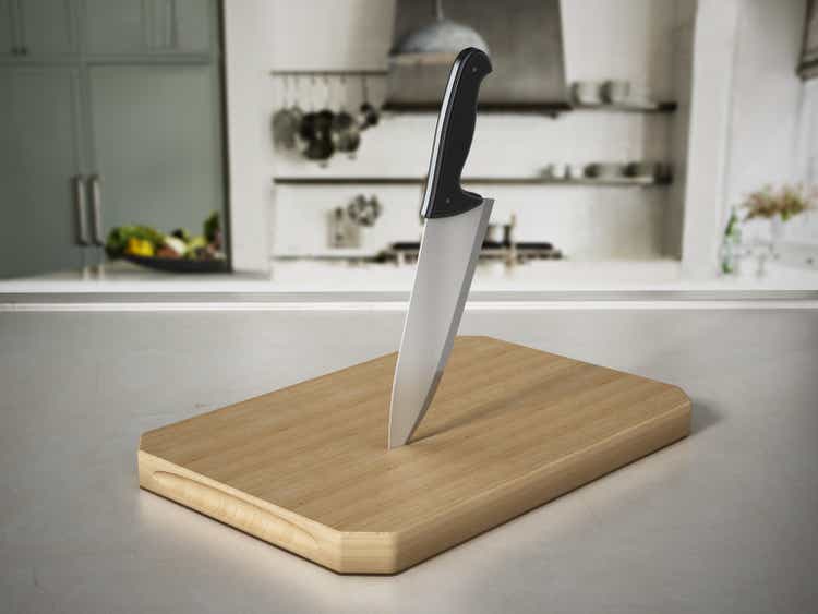 Kitchen knife on cutting wood standing on kitchen counter