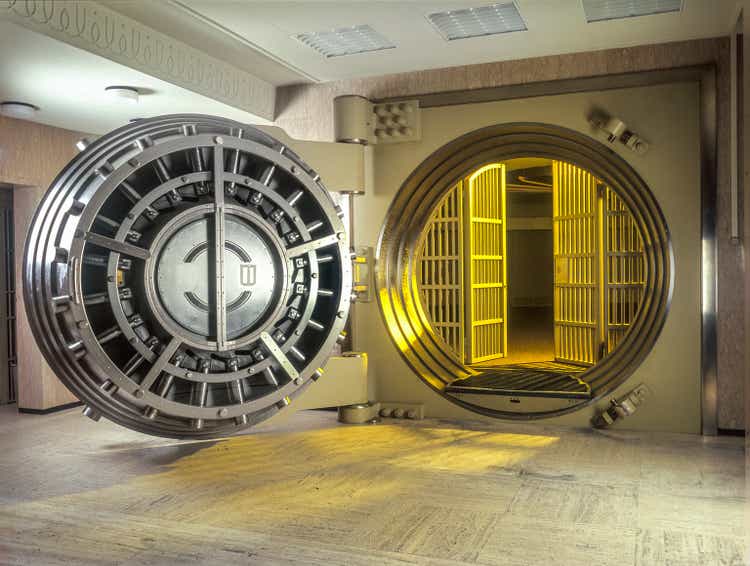 Very large Open Safe With golden Light shining from within the safe.