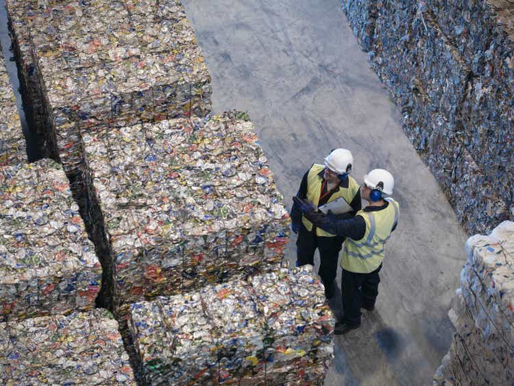 Workers With Bales Of Tin Cans