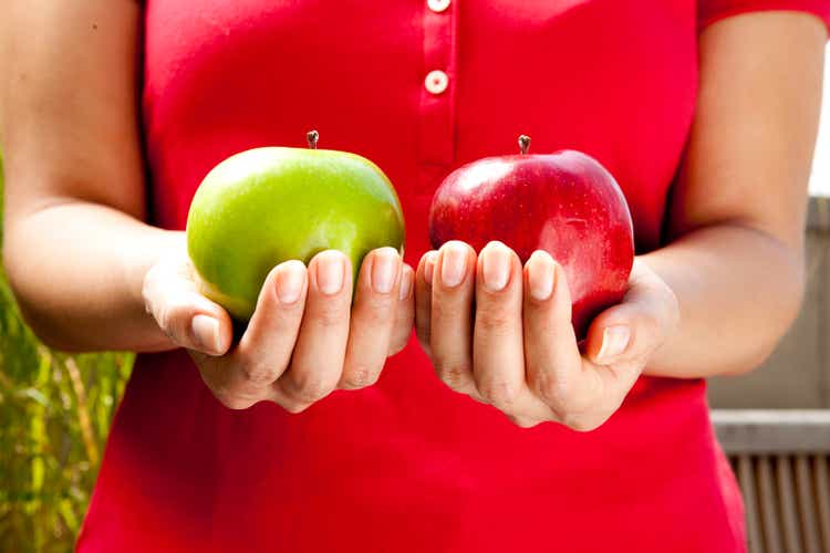 Woman holds two apples