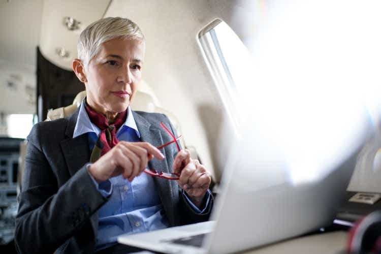 Businesswoman in private jet airplane