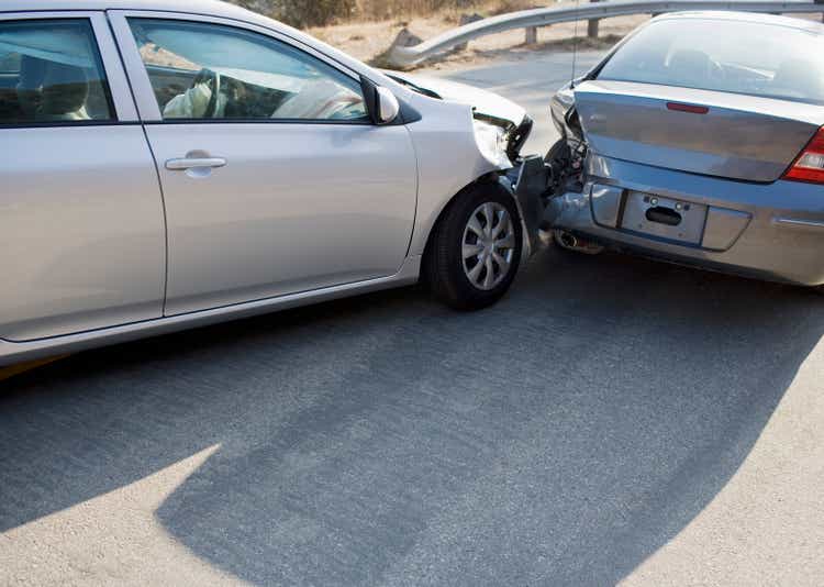 Two cars collide on the road