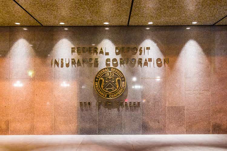 FDIC United States Federal Deposit Insurance Corporation sign on wall of building with logo on 17th street in evening night closeup