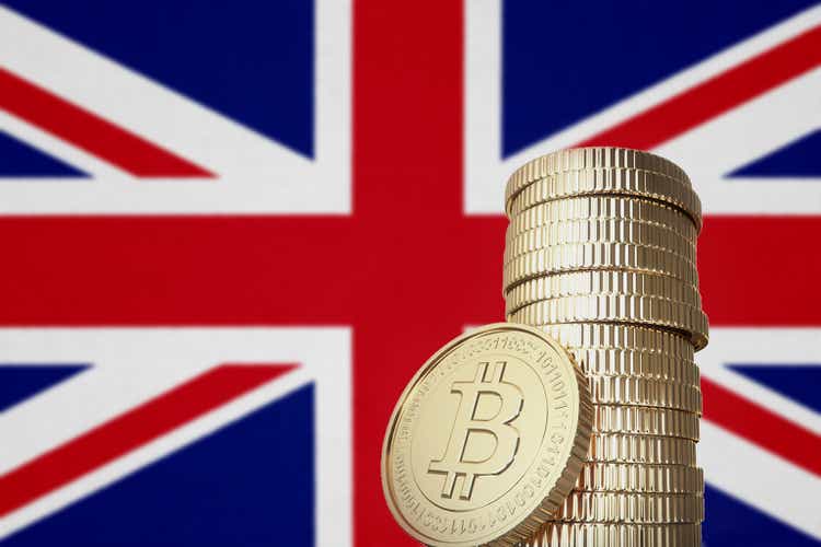 Bitcoin stack with Great Britain flag in the background