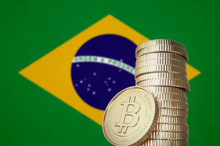 Bitcoin stack with Brazil flag in the background