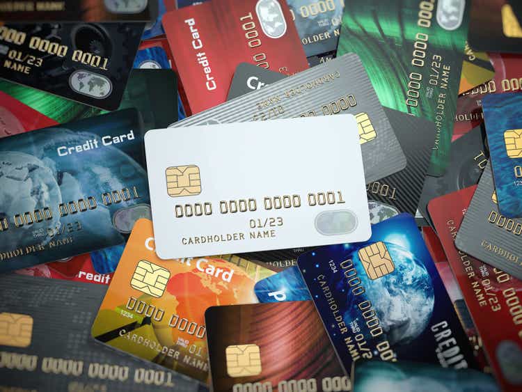 White blank credit cards mockup onthe background of colorful credit cards of the different banks.