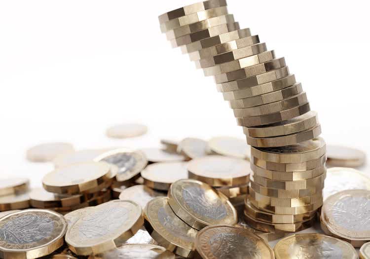 Falling stack of British one pound coins