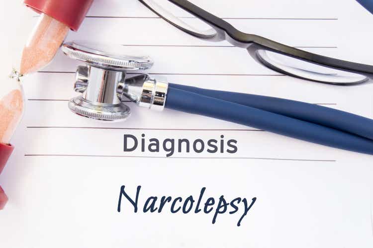 Diagnosis Narcolepsy. Psychiatric diagnosis Narcolepsy is written on paper, on which lay stethoscope and hourglass for measuring time to research. Concept photo for psychiatry or psychology