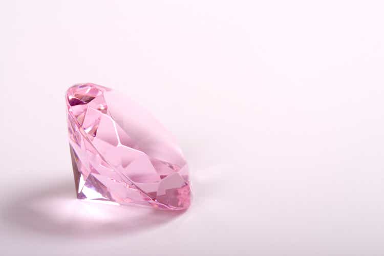 Single pink diamond on white background copyspace right