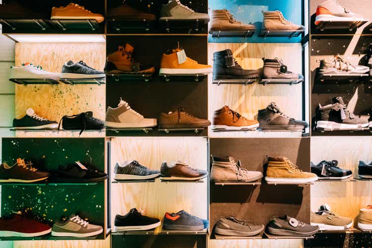 Fashion Casual Male Sneakers On Shelves In Store Of Shopping Center